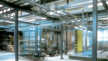 Overhead monorail system in a paint finishing system with shifting bridge